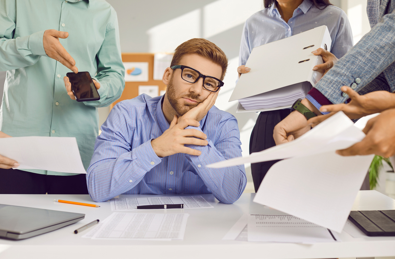 Stress, Burnout and Tired Man Frustrated or Overwhelmed by Coworkers at Workplace at Office.